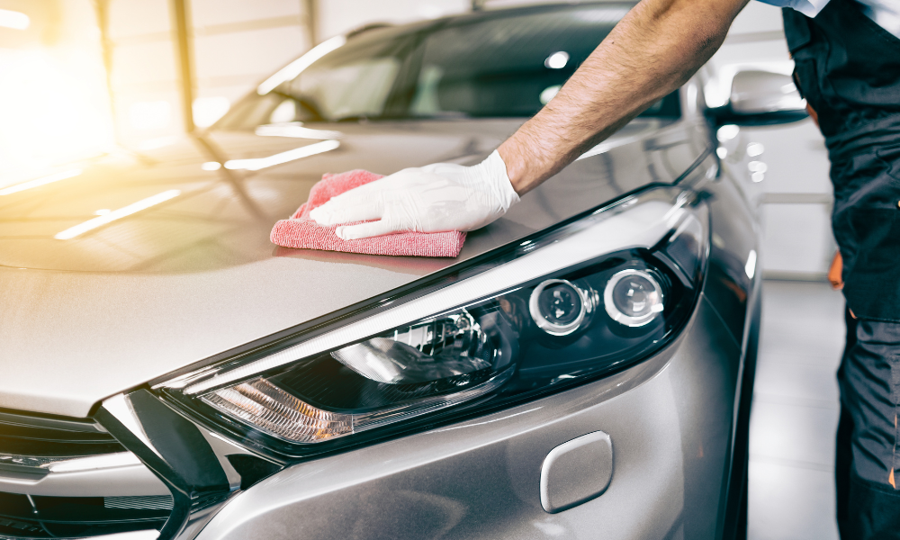 Professional exterior detailing technician polishing car paint